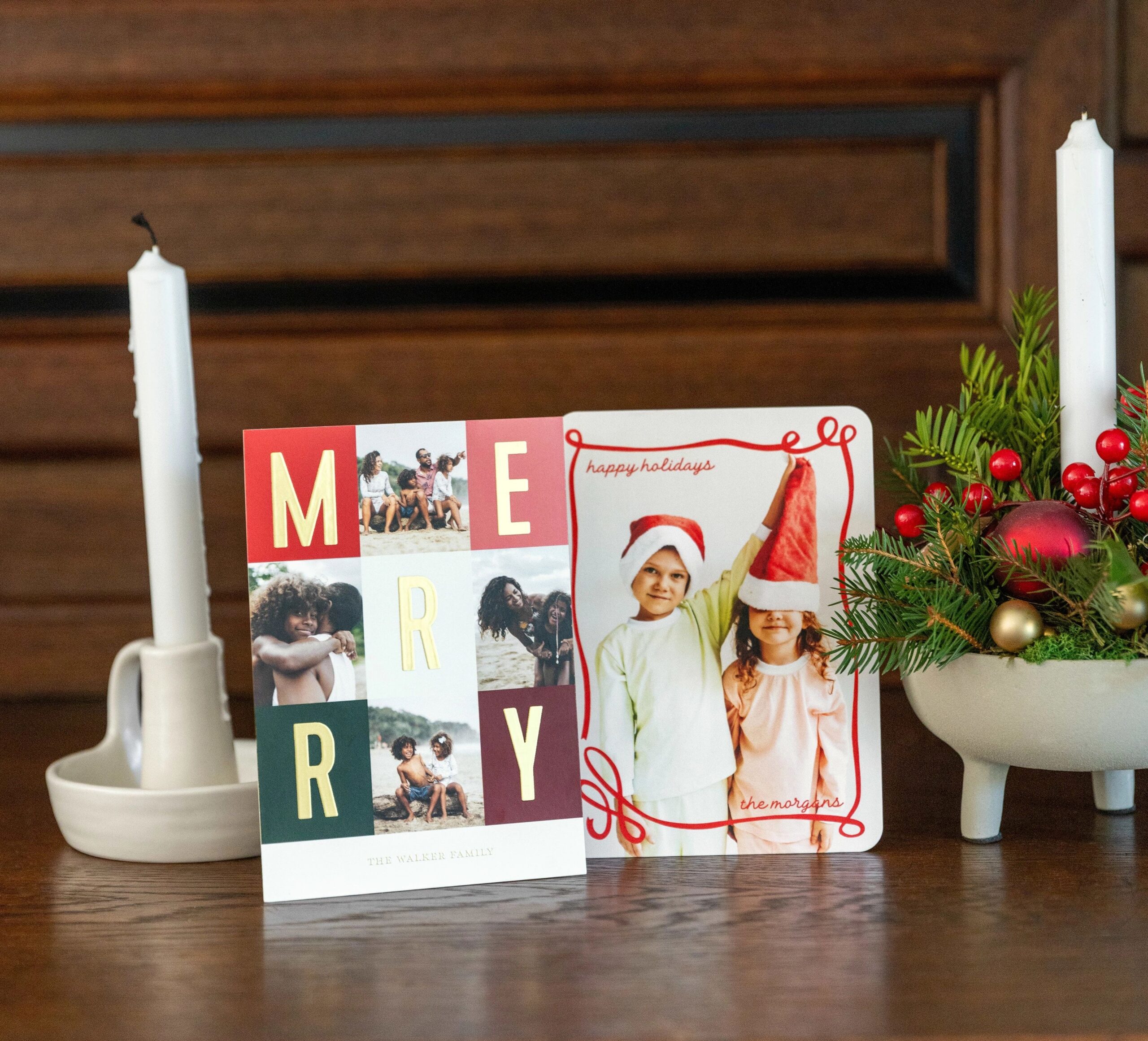 two christmas cards on a mantle