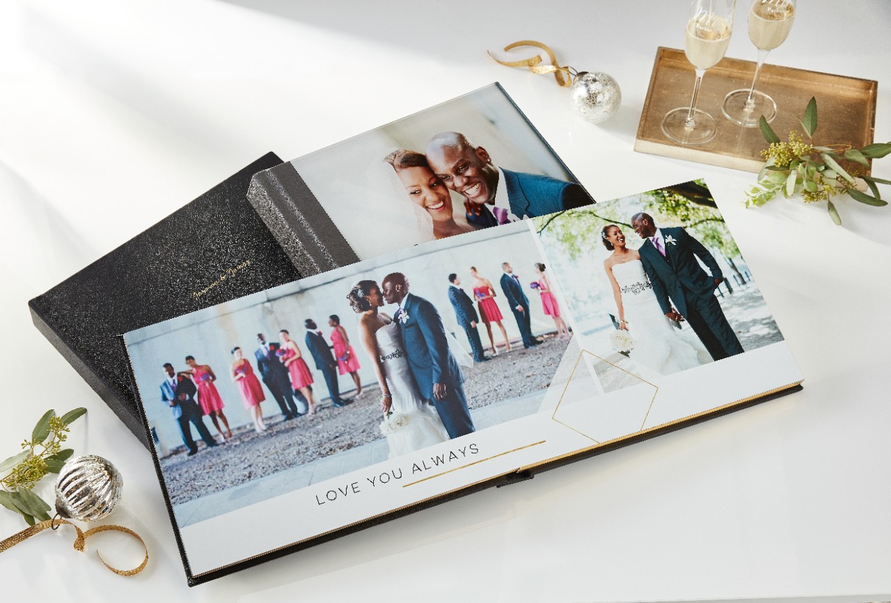 a display of a wedding photo books with layflat pages and a leather cover