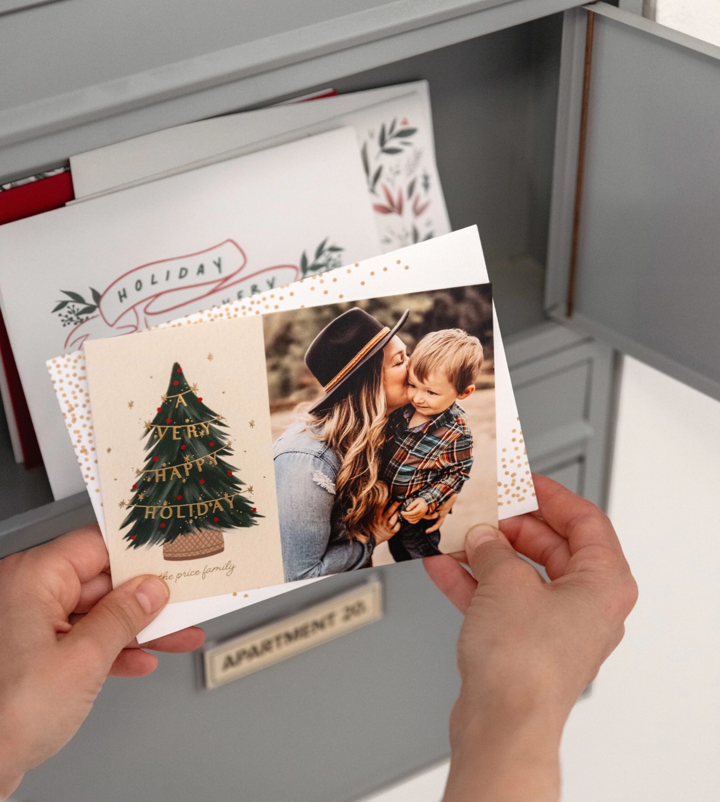 taking holiday card out of a mailbox