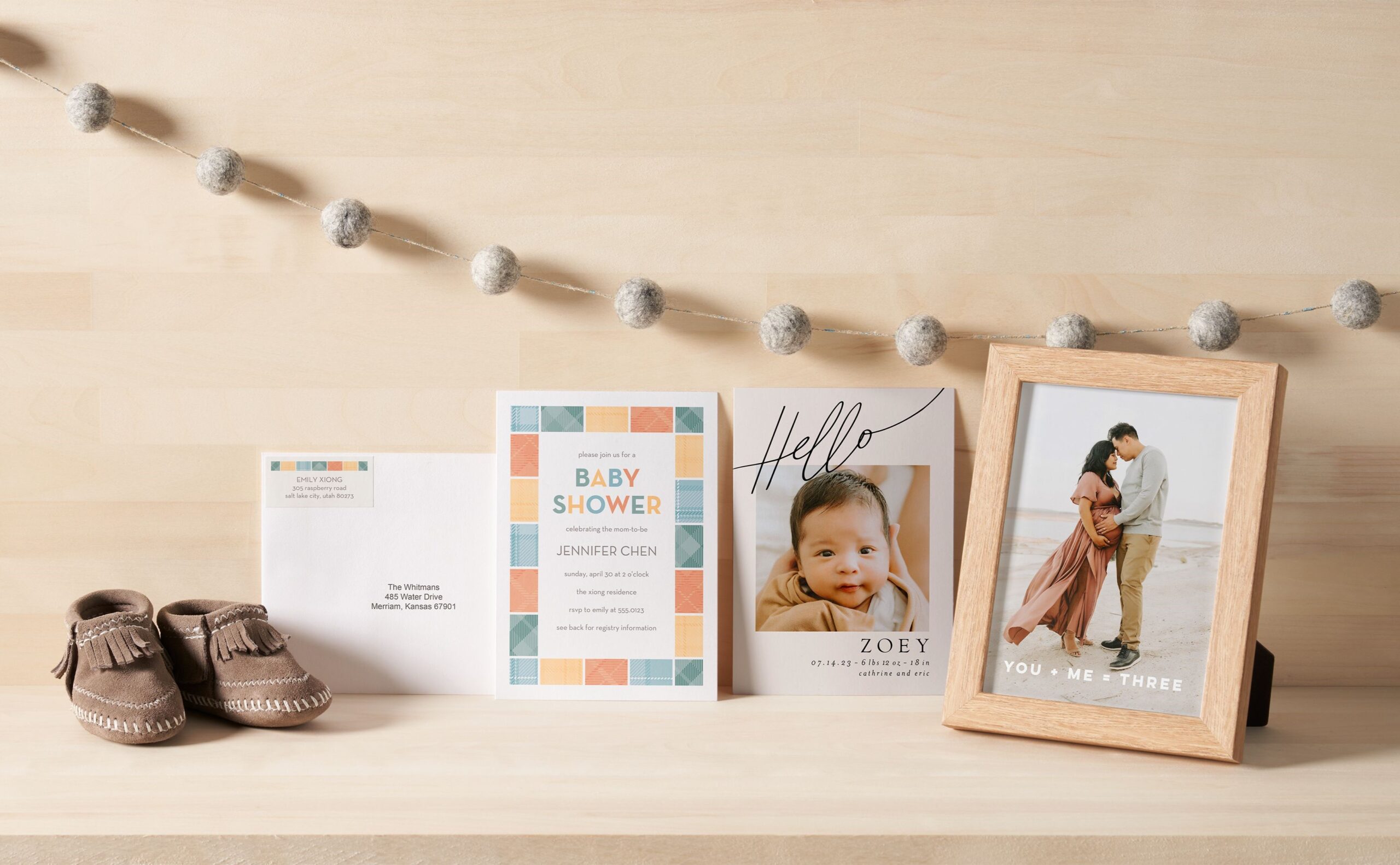 baby items like baby shower invitations, birth announcement, and framed photo