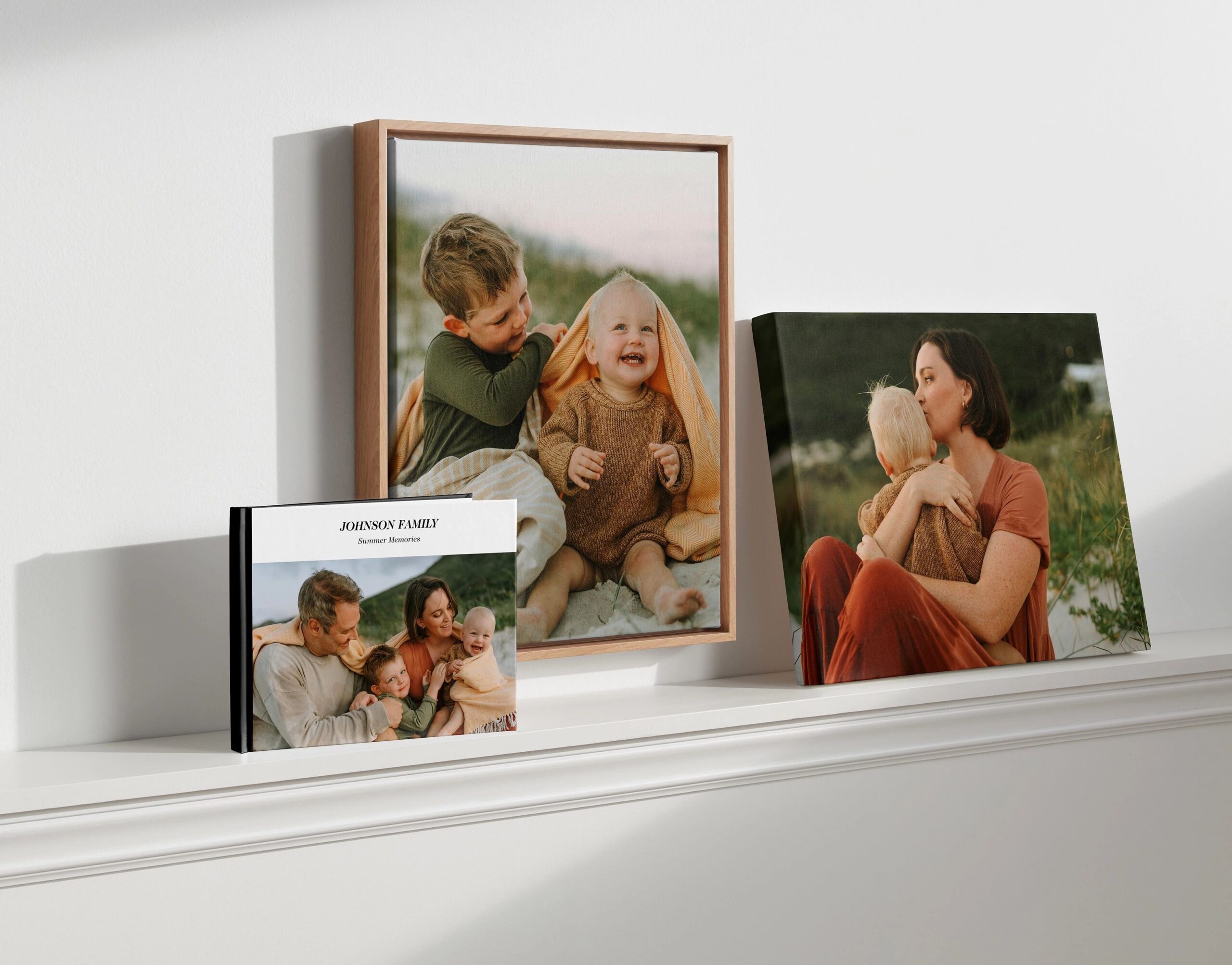wall art leaning against the wall on a shelf next to a photo book and canvas print