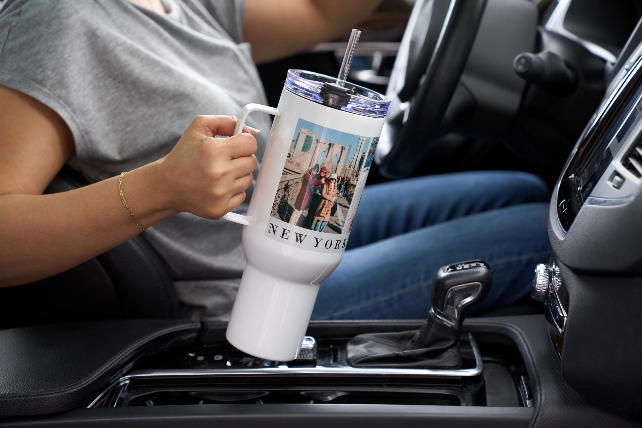 woman holding a personalized 40 oz tumbler with handle in the car
