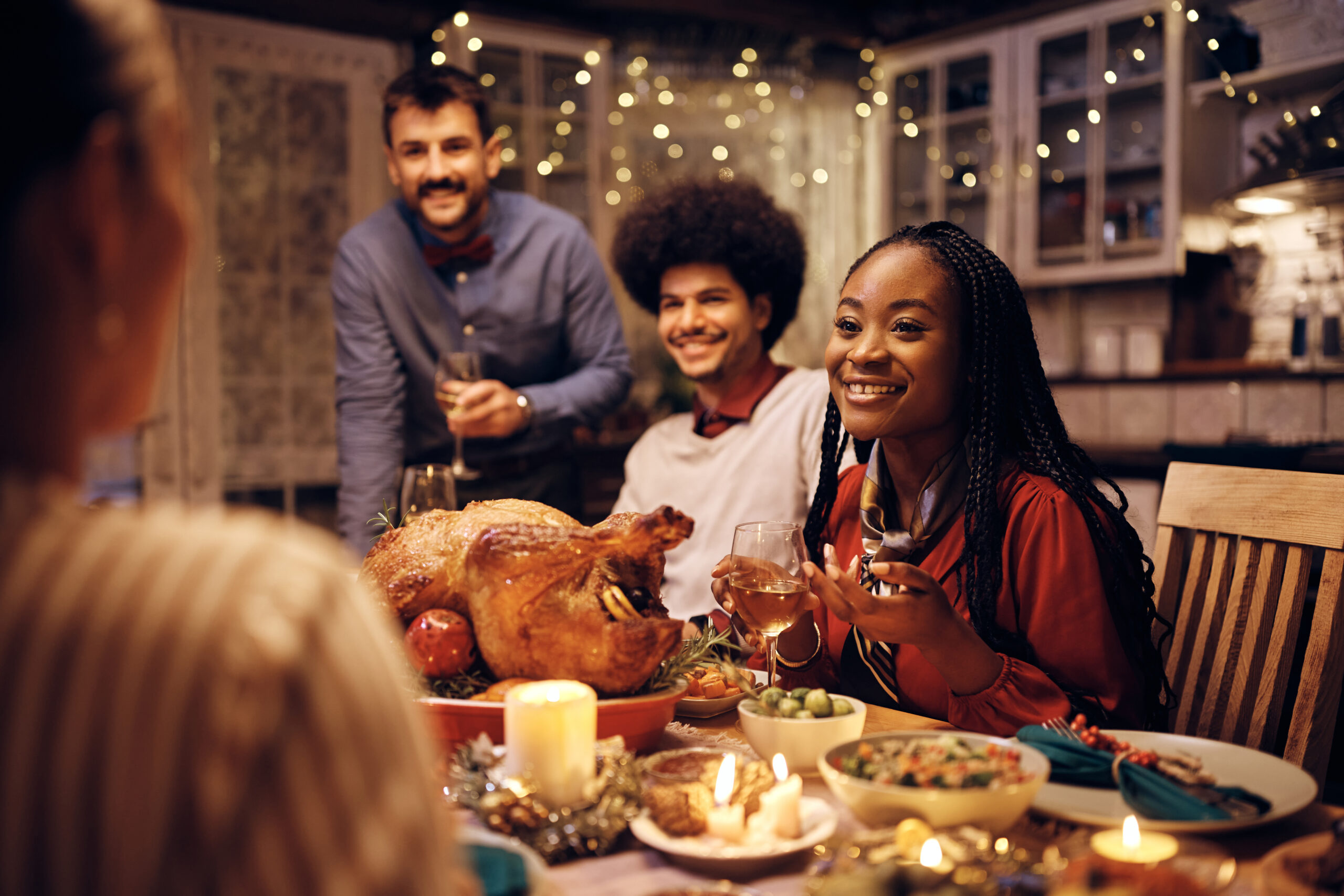 friends celebrating friendsgiving at dinner table