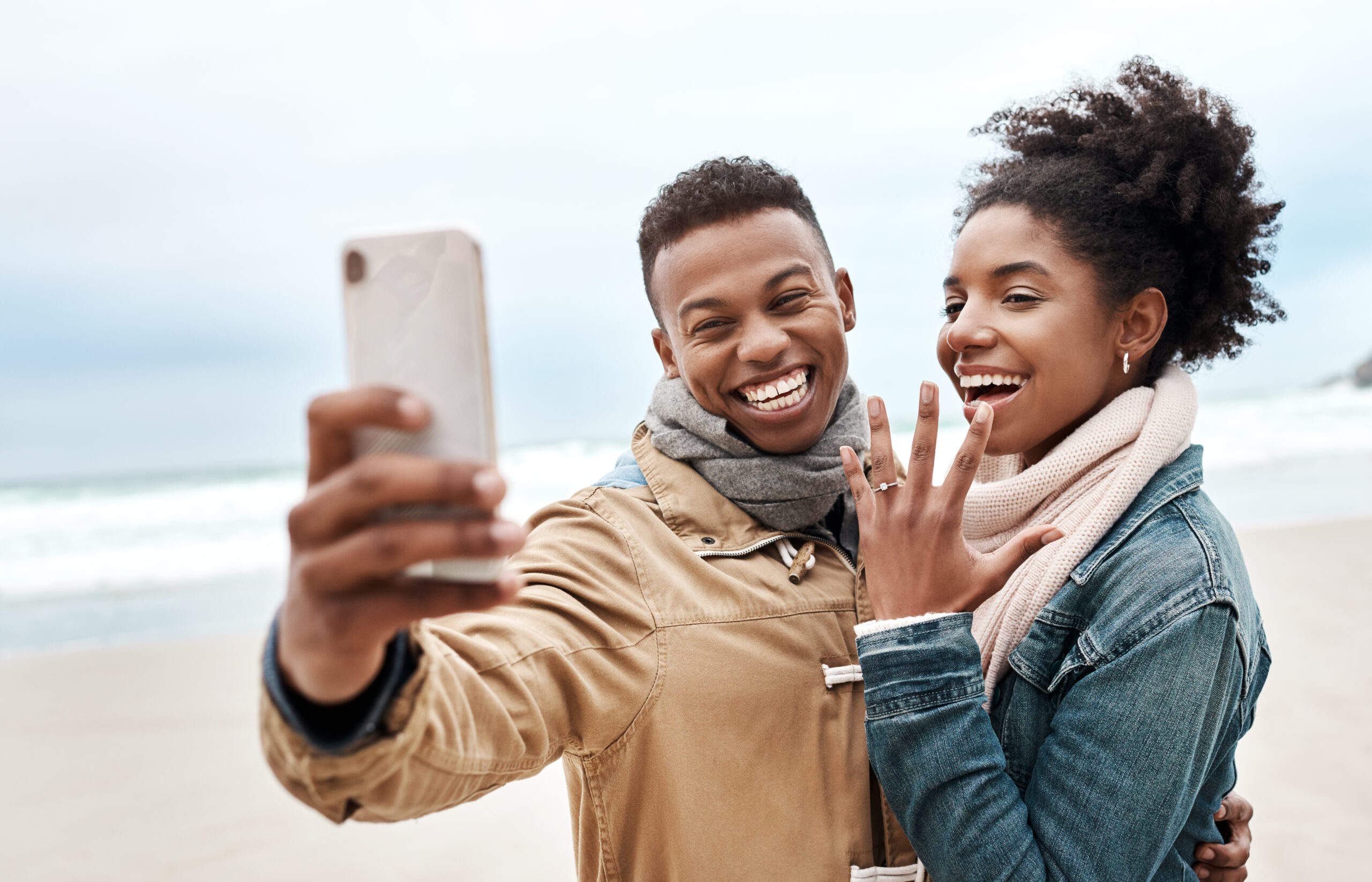 couple showing off engagement ring on facetime
