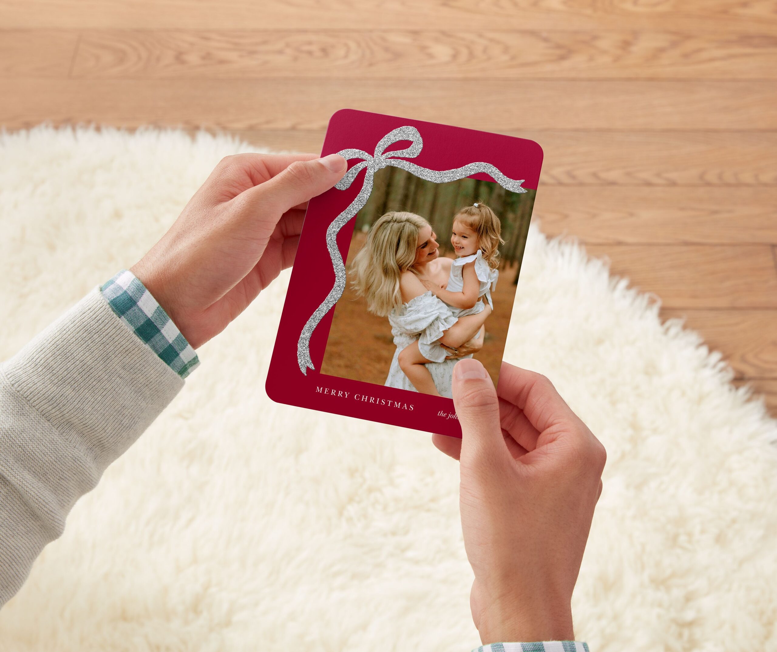 red christmas card with a bow and a mother holding a child